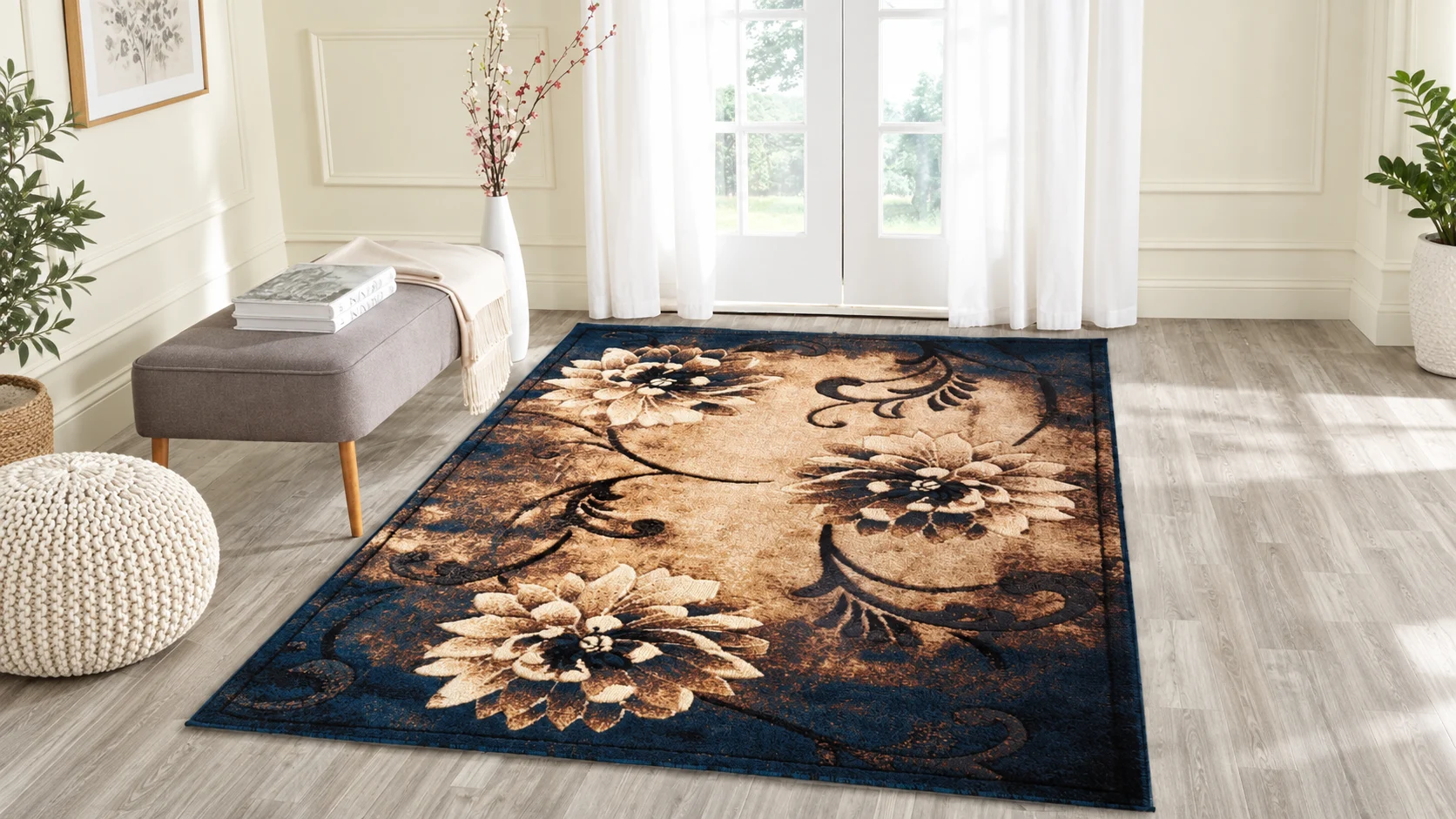Navy and gold floral rug beside a grey bench and sunlit French doors